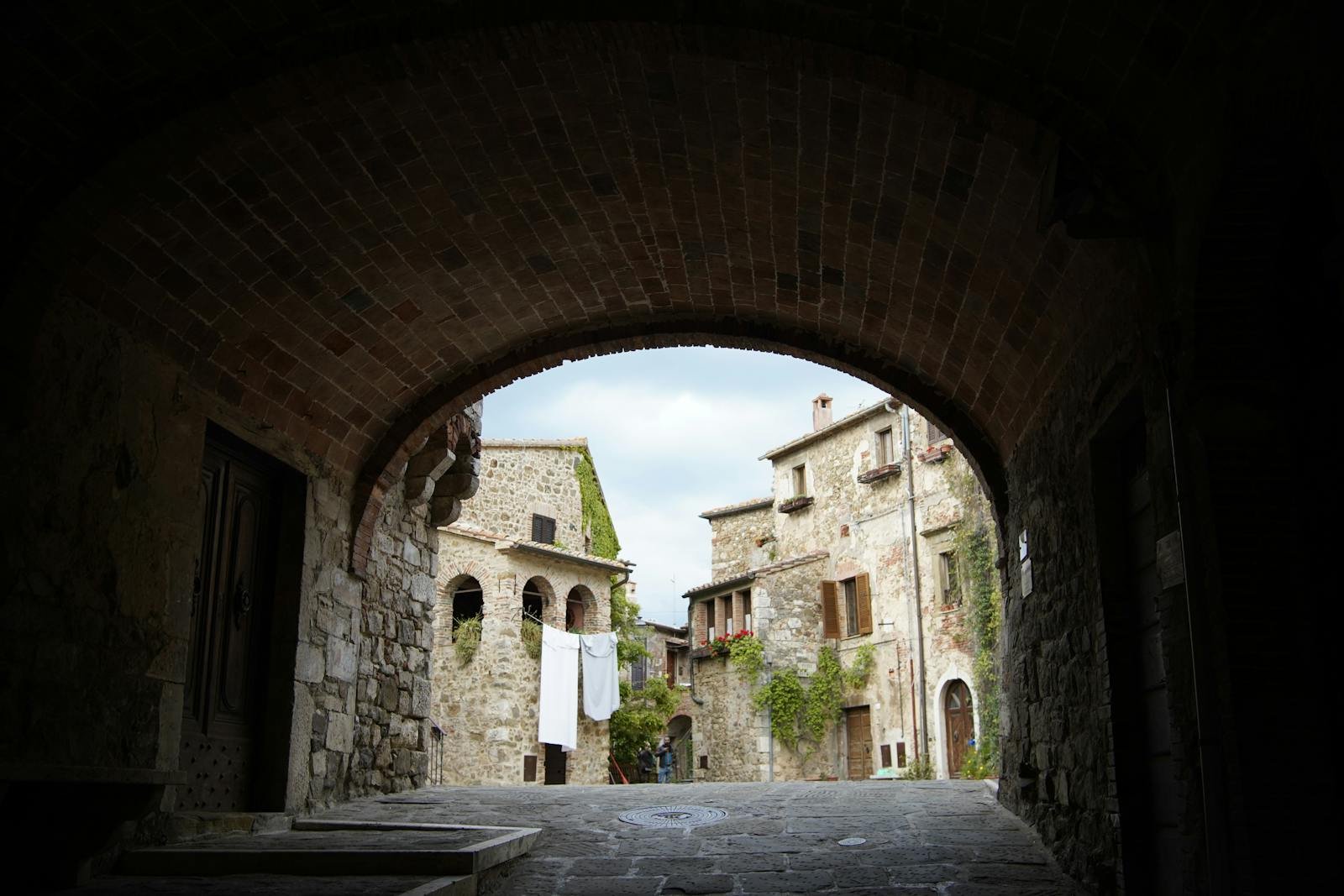 A view of an old stone building through an archway