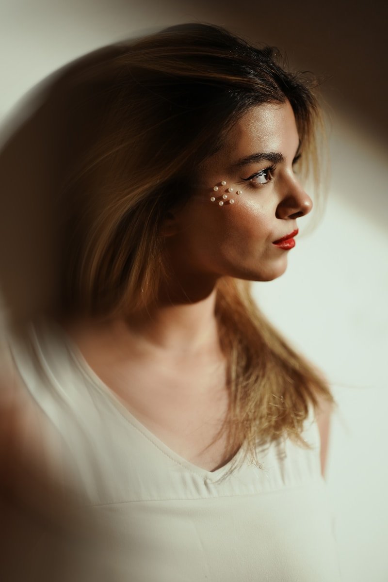 Woman with decorative pearls on cheek